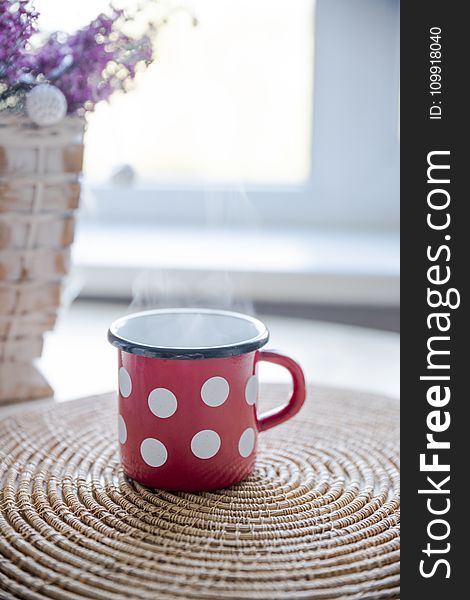 Red, White, and Black Ceramic Mug on Table