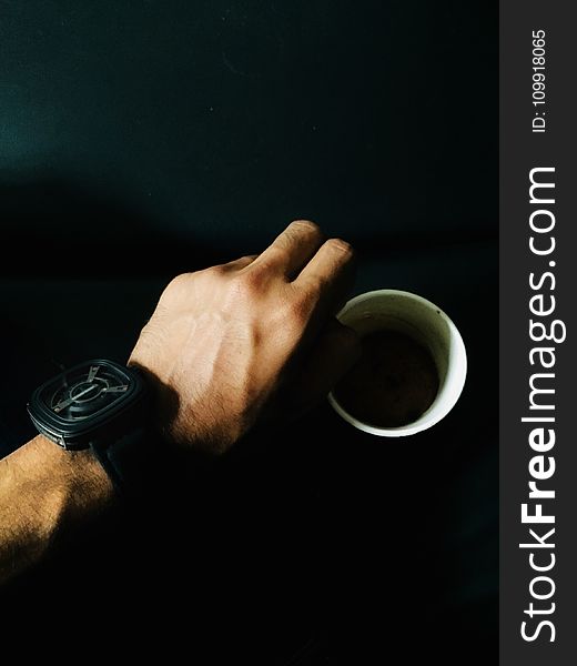 Person Hand and Cup of Coffee