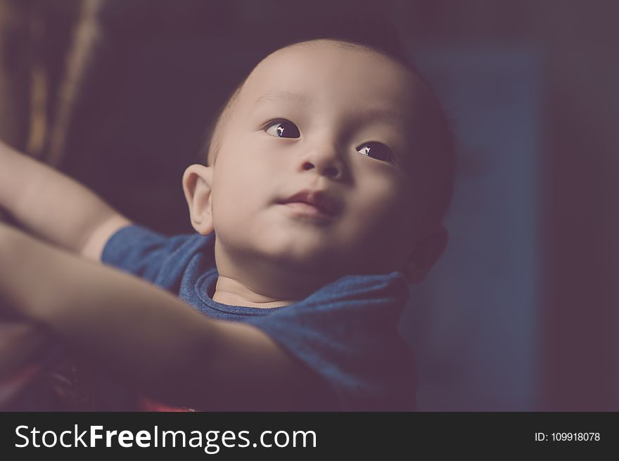 Close-Up Photography of Baby Looking Up