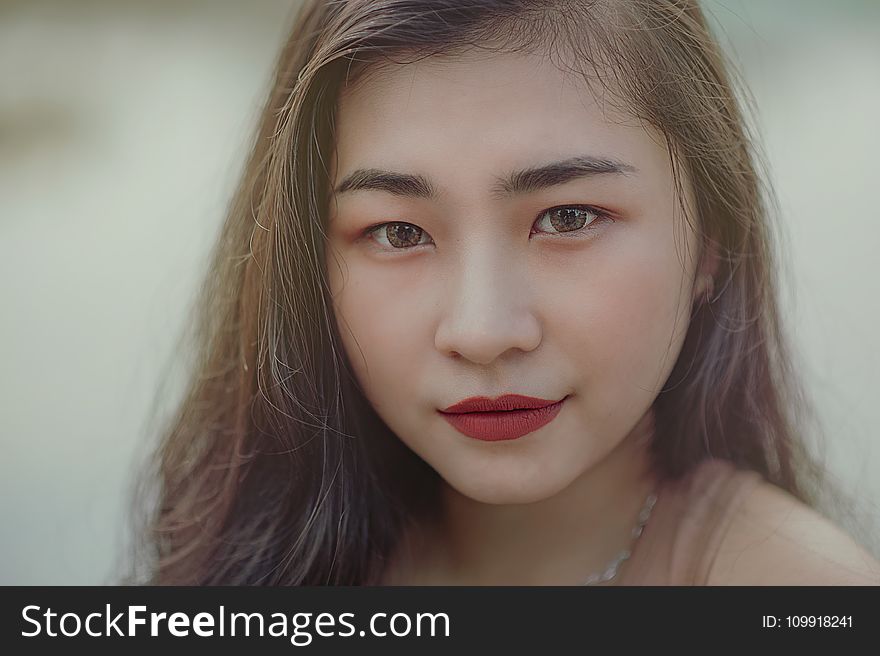 Close-Up Photography of Woman Wearing Red Lipsticks