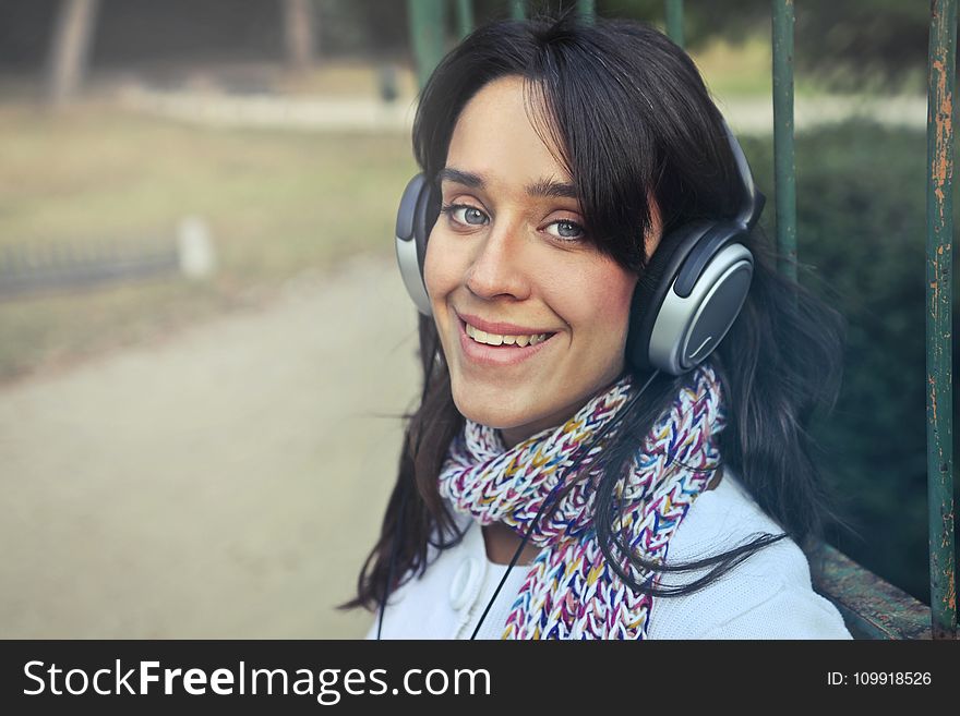 Woman Wearing Headphones With Scarf