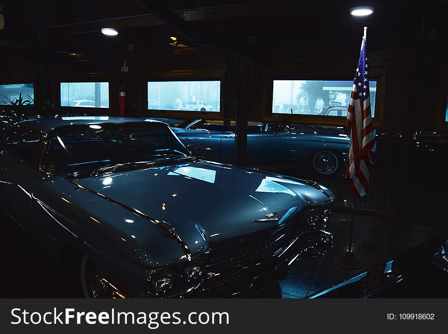 Classic Gray Chevrolet Car Near Us Flag Inside Garage