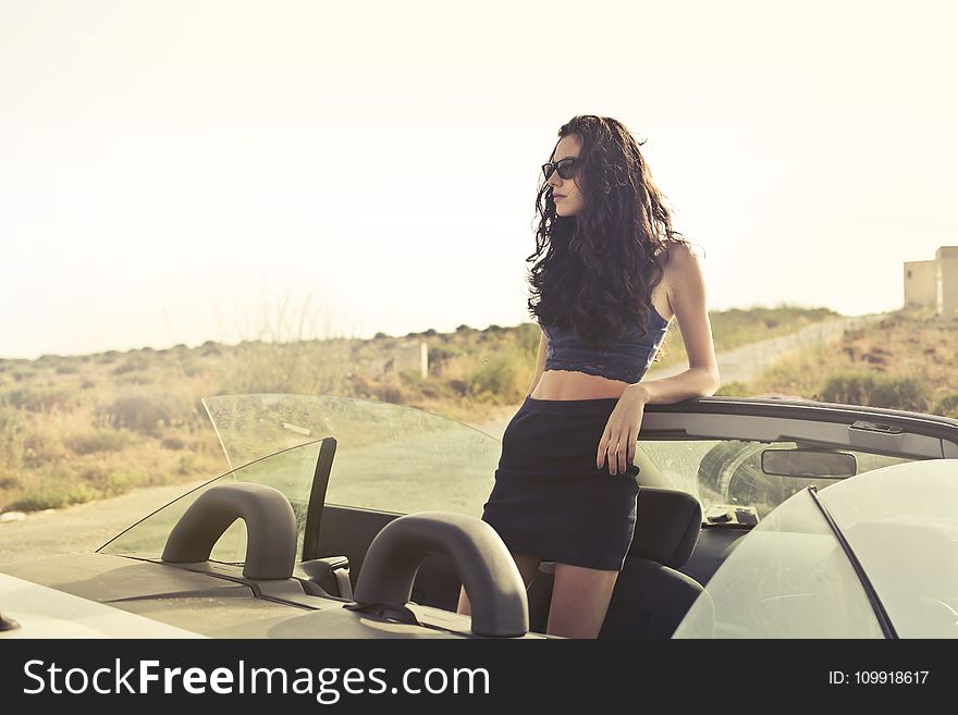 Woman Standing Leaning at Convertible Car