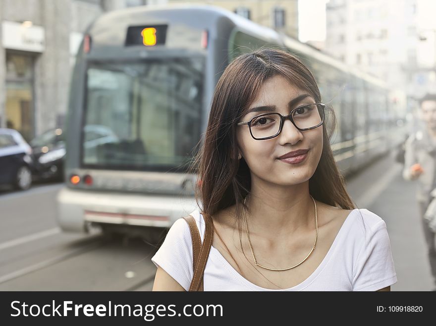 Woman in White Shirt With Eyeglasses Standing Near Train