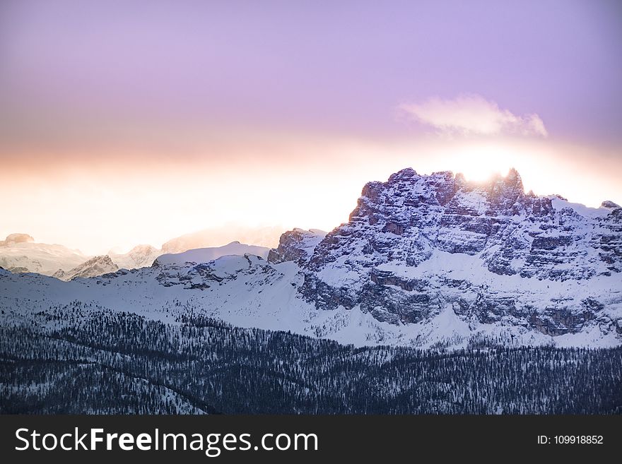 Mountain Cover by Snow Under Orange Sky