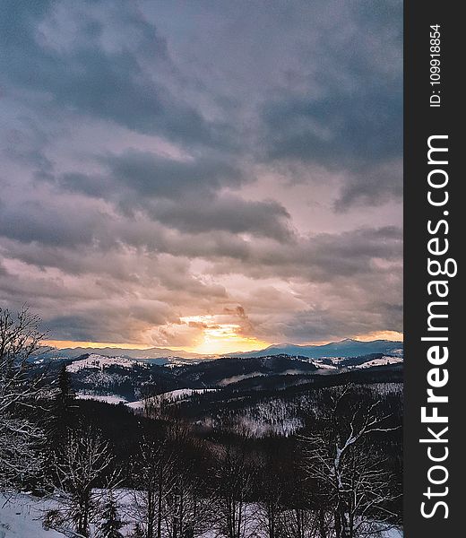 Photograph Of Snow Covered Mountains During Sunrise