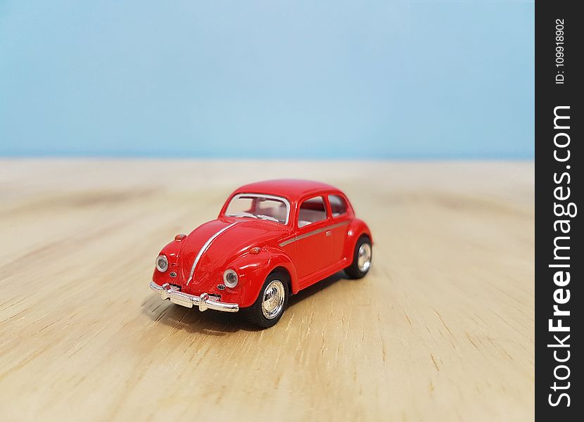Depth of Field Photography of Red Volkswagen Beetle Diecast Model
