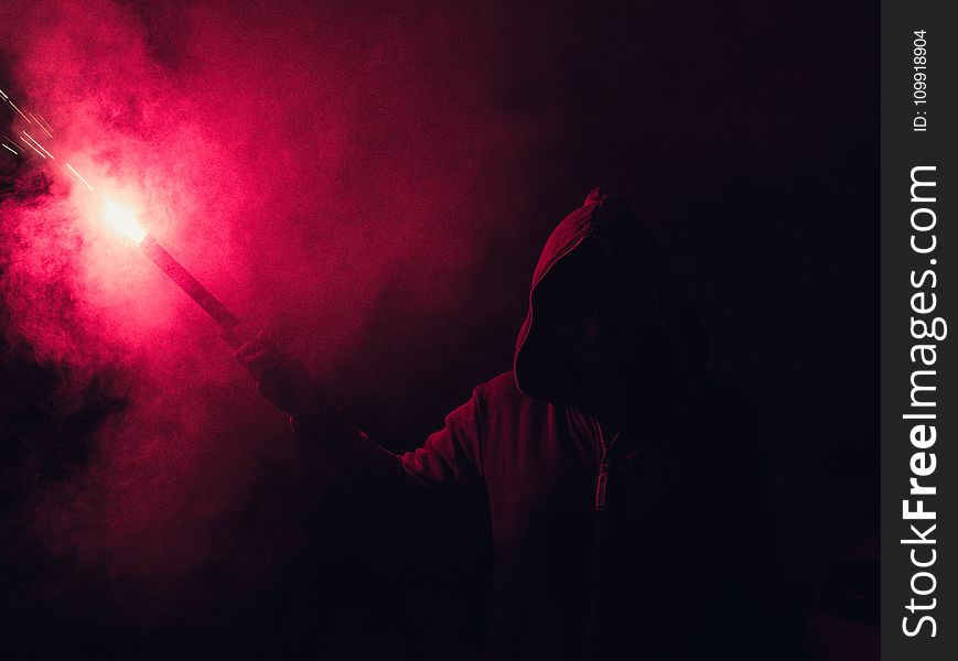 Hooded Figure Holding Red Flare