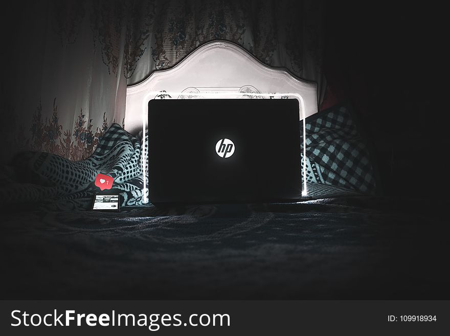 Black Hp Laptop on Bed Is on