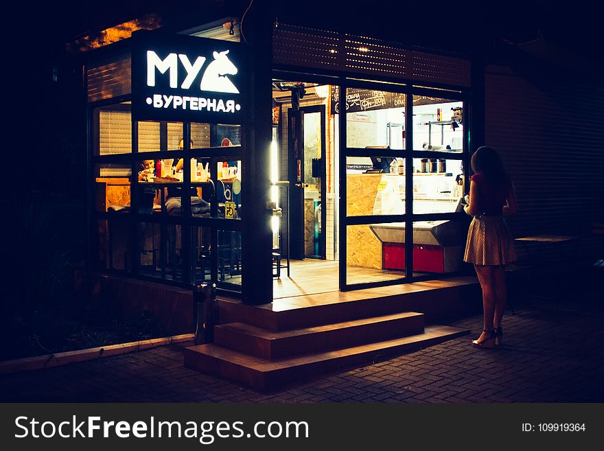 Photography Of Woman Standing Near Restaurant