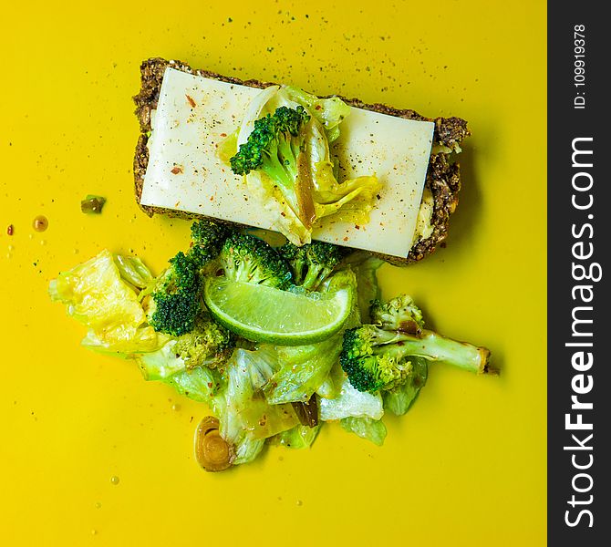 Photo of Green Broccoli, White Cheese and Green Cabbage on Yellow Surface