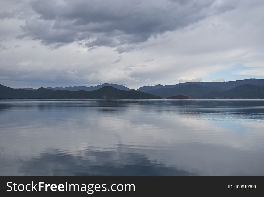 Photography Of Mountains Near Body Of Water