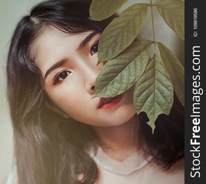 Photography Of Brown Haired Woman Near Green Leaves