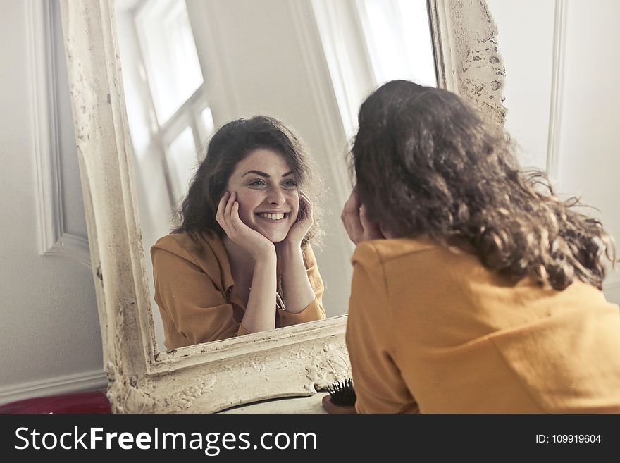 Photo Of Woman Looking At The Mirror