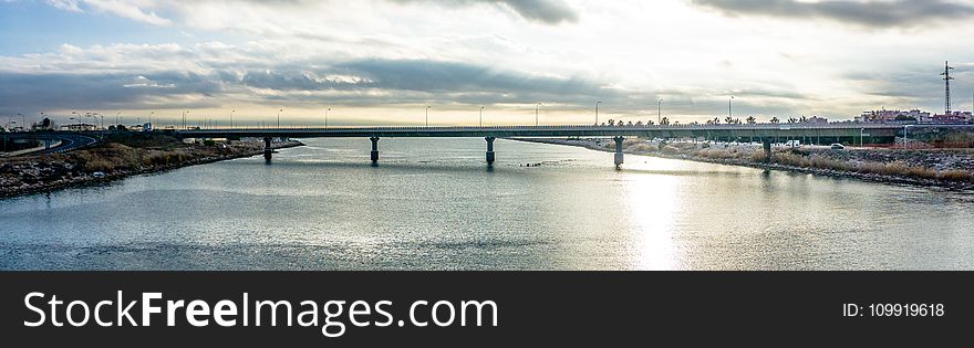 Panoramic Photography of Bridge Under Cloudy Sky
