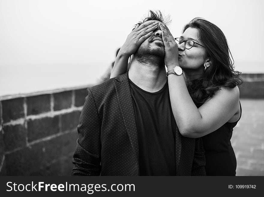 Grayscale Photography of Woman Covering Eyes of Man
