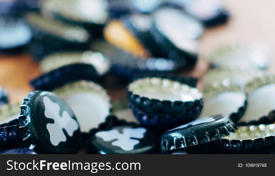 Close-up Photography Of Black Bottle Cap Lot