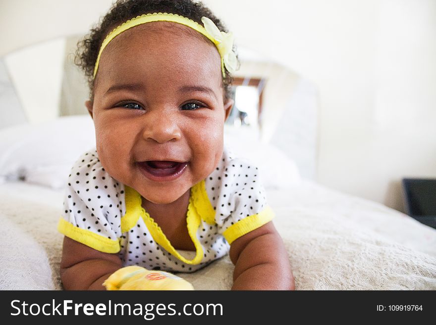 Baby Wearing White And Yellow Shirt