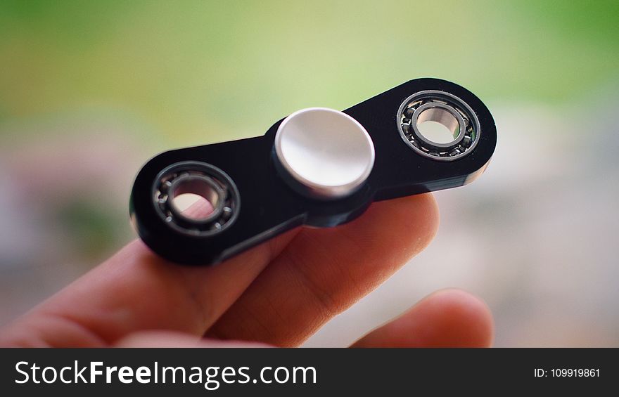 Person Holding Black Finger Spinner