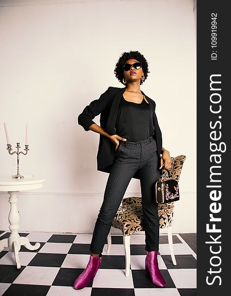 Woman in Black Blazer and Black Slacks With Purple Boots Photo