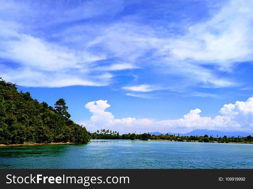 Ocean Under Blue Sky And White Clouds