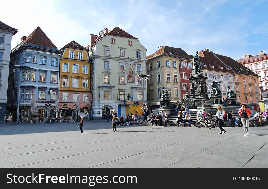 People Walking In Front Of Buildings