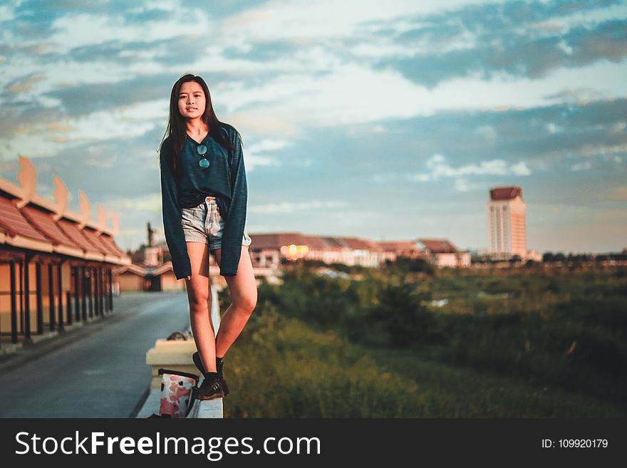 Woman Standing On Edge Of Wall