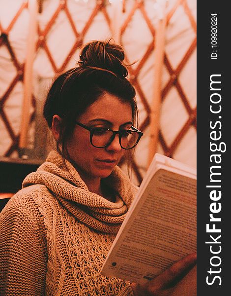 Photo of Woman Wearing Gray Scarf Reading Book