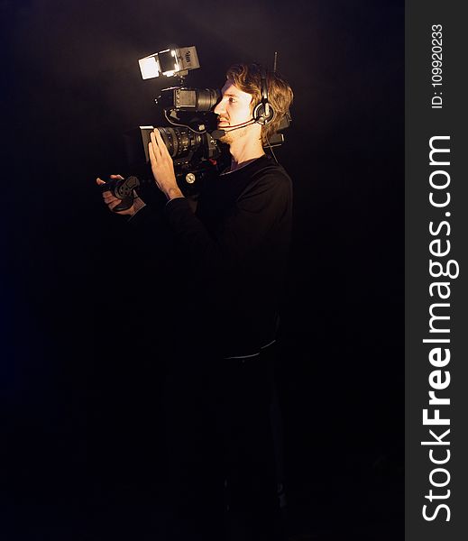 Man Wearing Black Long-sleeved Shirt Using Video Camera