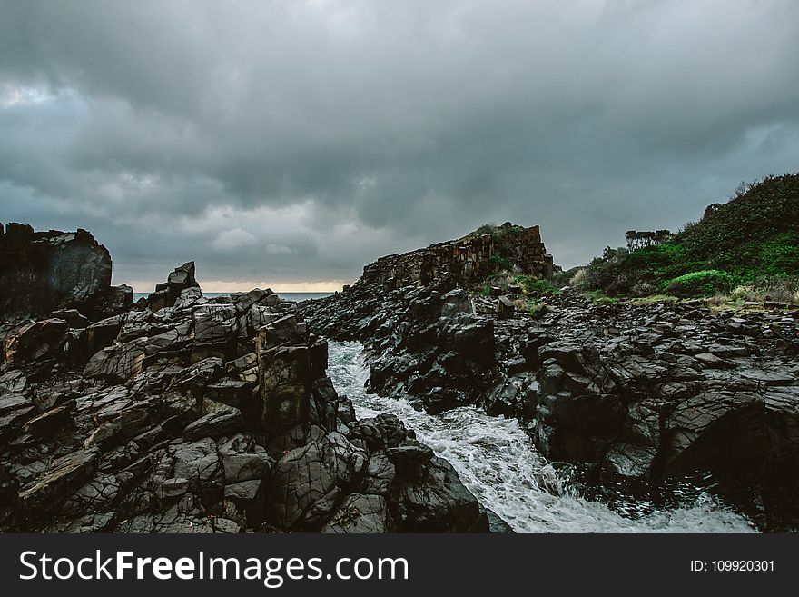 Rocky River Under Cloudy Sky