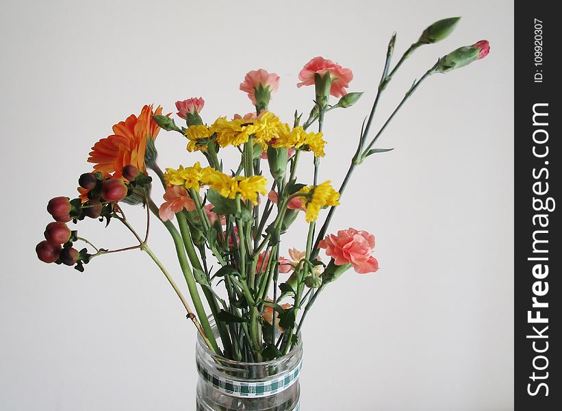 Clear Glass Vase With Red and Yellow Flowers