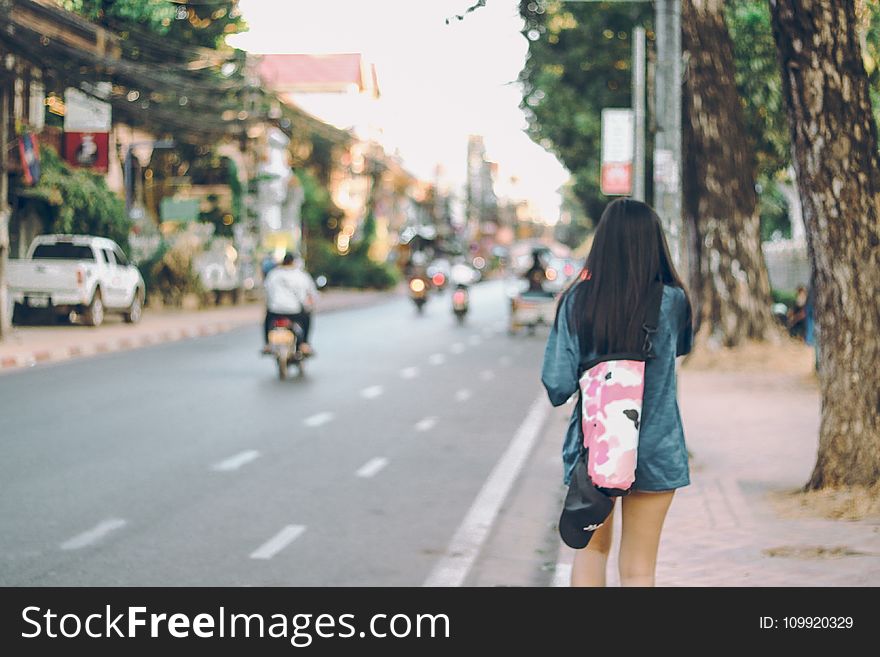 Photo of Woman Walking in the Street