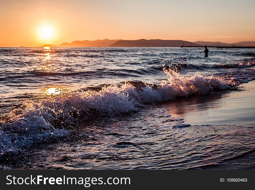 Person on Beach during Golden Hour