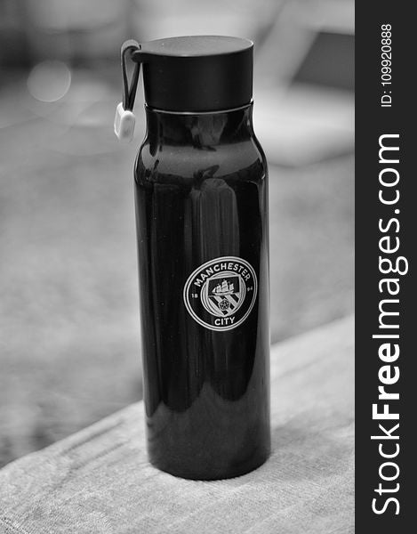 Selective Focus Photography of Manchester City Sports Bottle