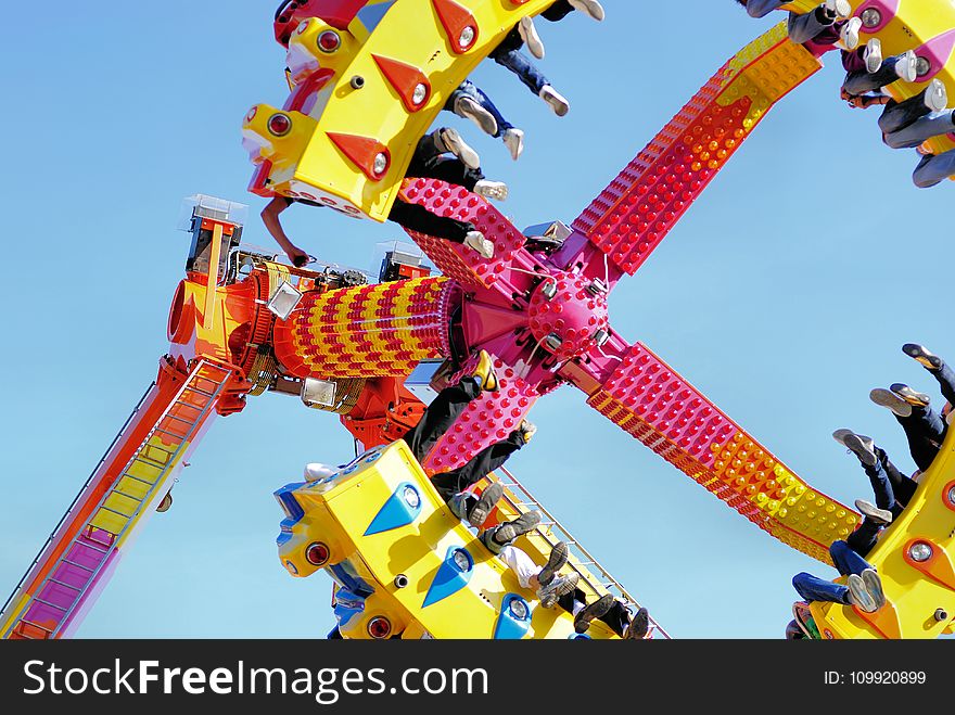 People Riding a Swing in the Amusement Park