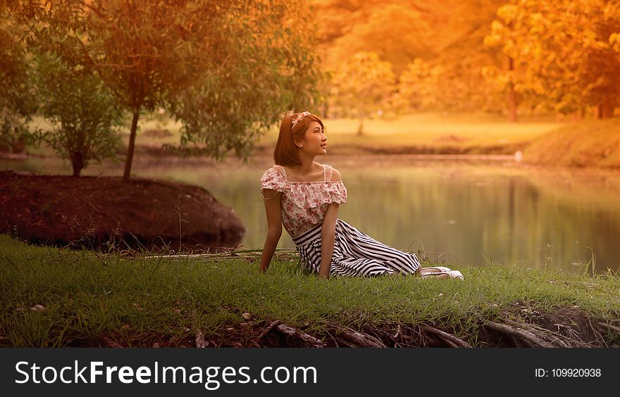 Woman In Dress Lying On Grass