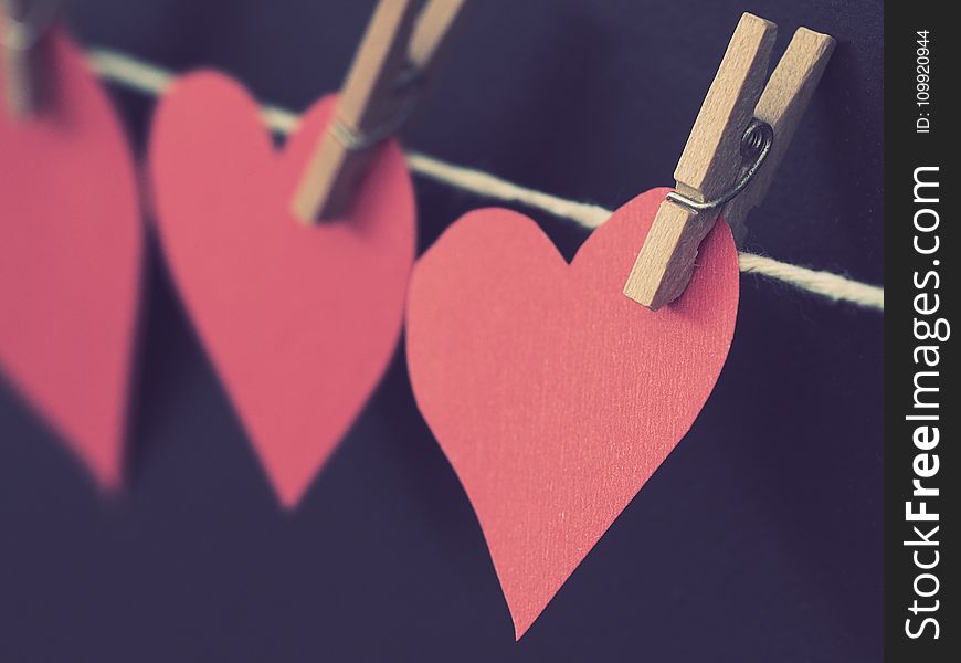Photo of Red Heart-shaped Paper Hanging on Rope