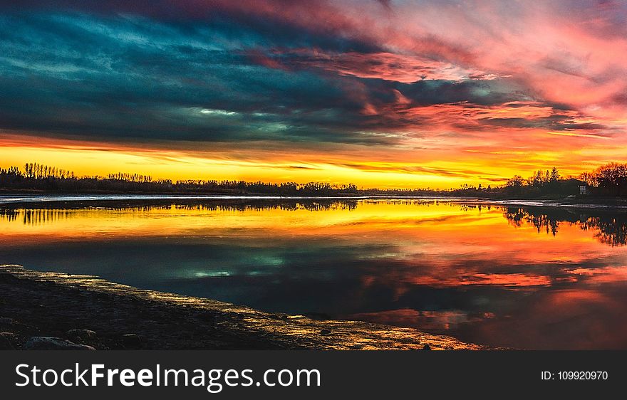 Body Of Water Under By Cirrus Clouds During Golden Hour