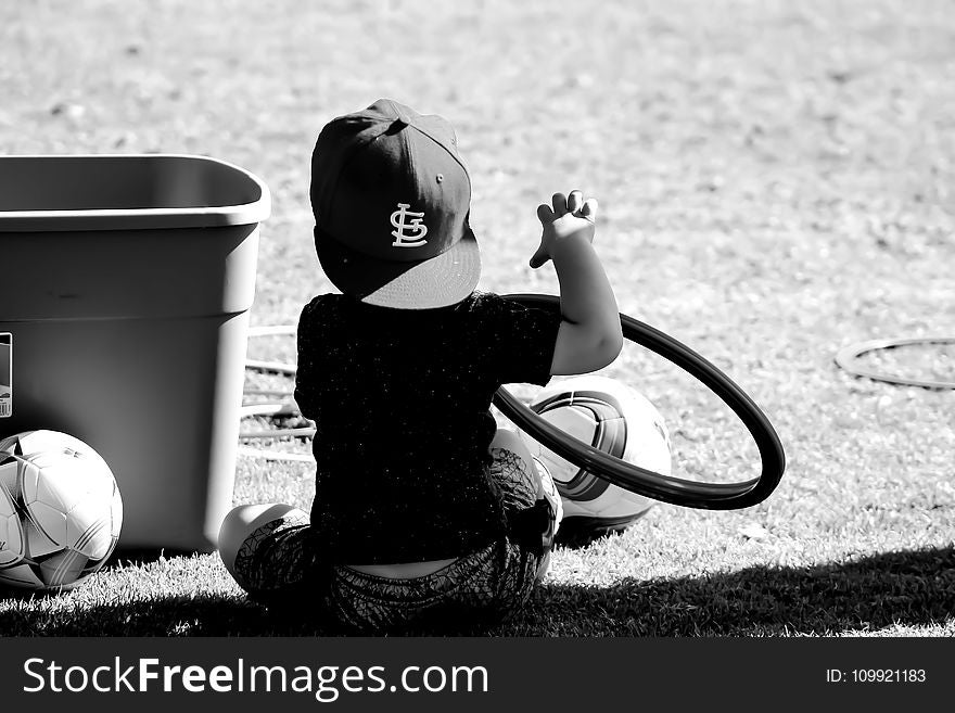 Grayscale Photo of Boy Wearing St. Louis Cap