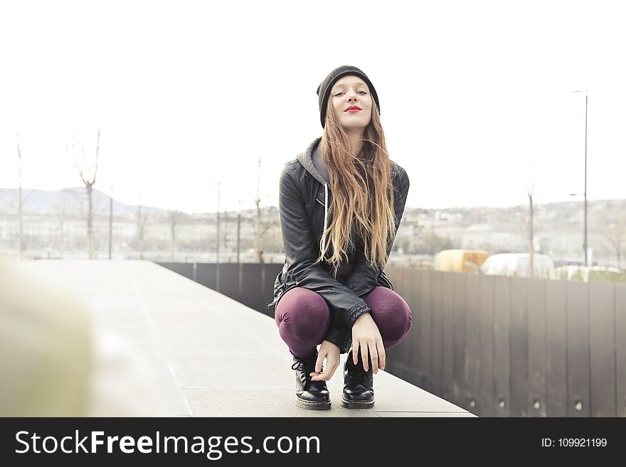 Selective Photo of Woman in Gray Hooded Jacket Doing Crouch Position
