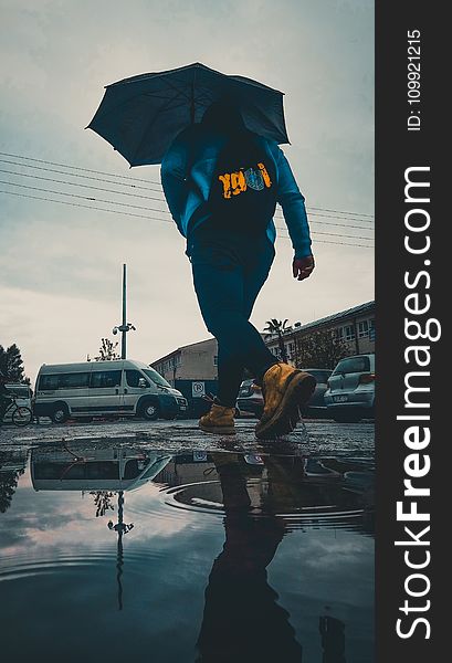 Person In Hoodie Holding Umbrella