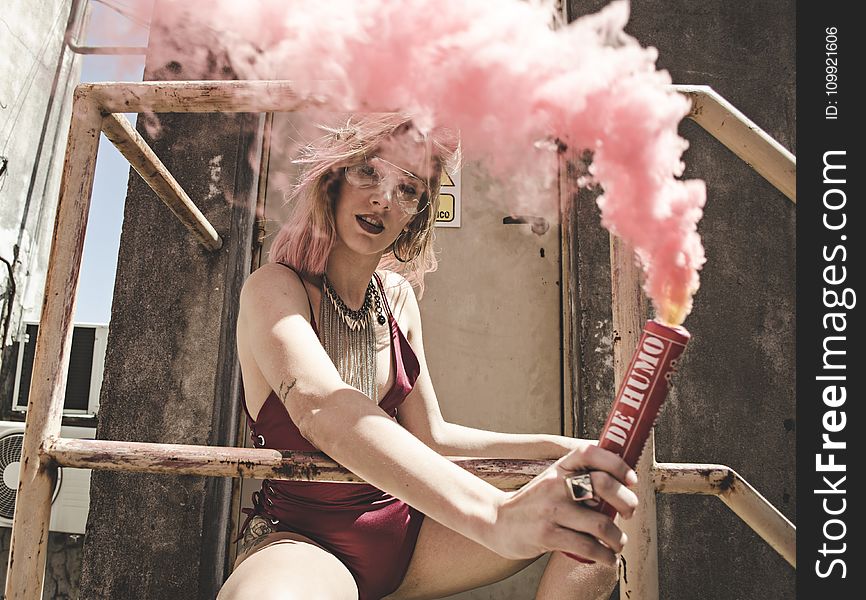 Woman In Maroon Monokini Holding Dynamite