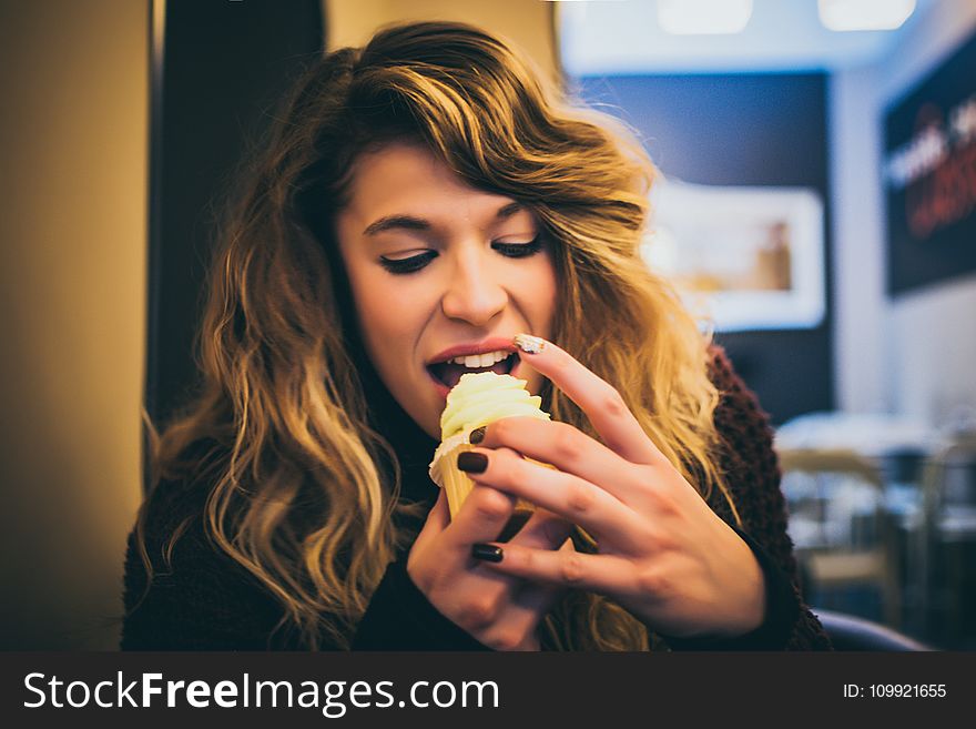 Long Blonde Haired Woman Eating Ice Cream