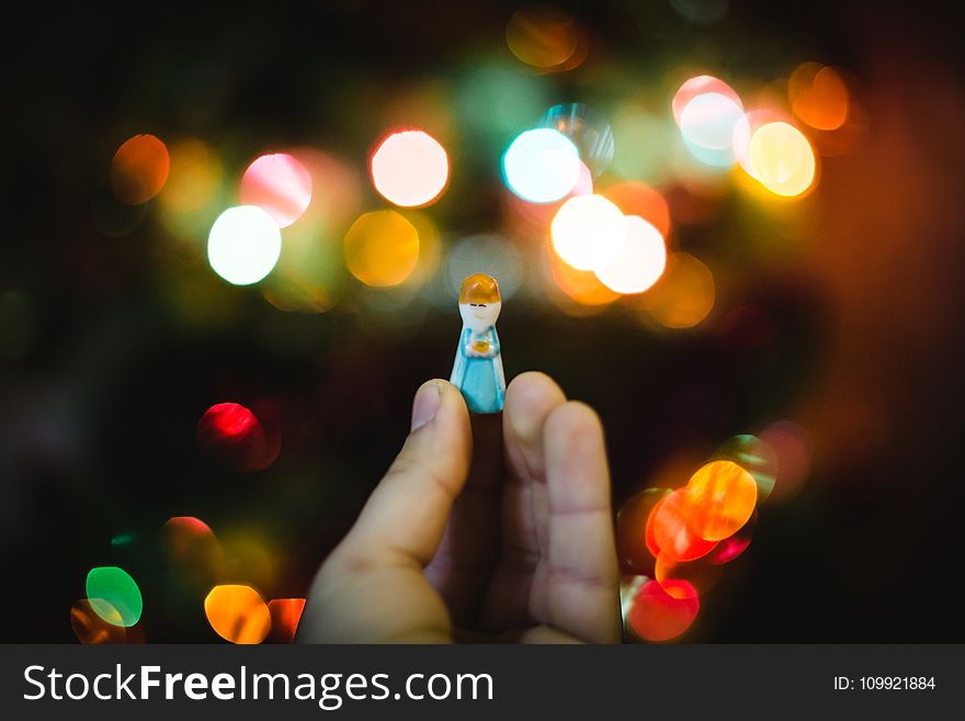 Person Holding Woman Wearing Dress Plastic Toy