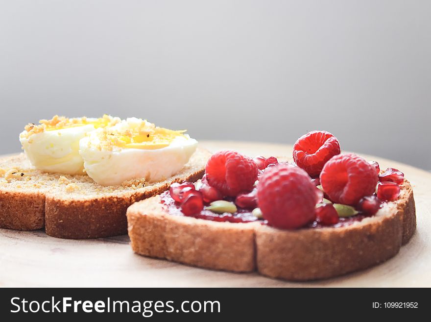 Two Boiled Egg and Raspberries on Loaf Bread