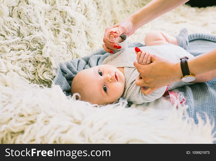 Baby in Gray Long-sleeved Onesie Lying on Beige Fur Textile