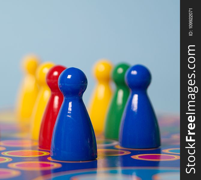 Closeup Photography of Yellow, Red, Green, and Blue Chess Piece