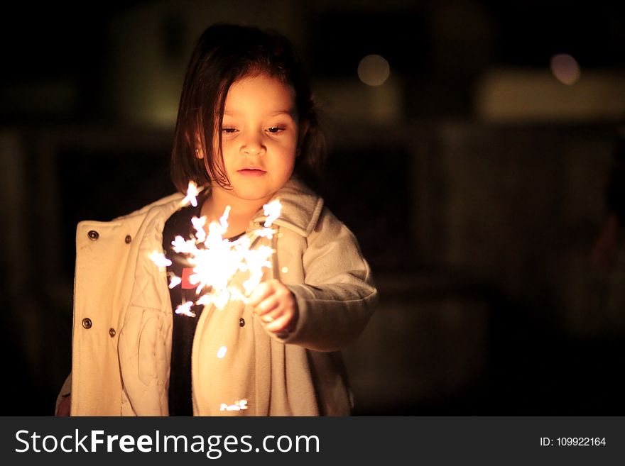 Girl In Beige Button-up Coat Holding Fireworks