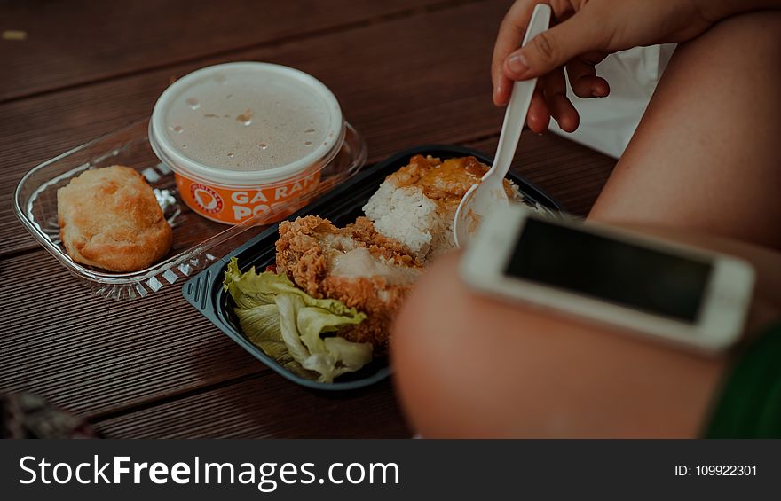 Person Holding White Disposable Spoon Eating Fried Chicken