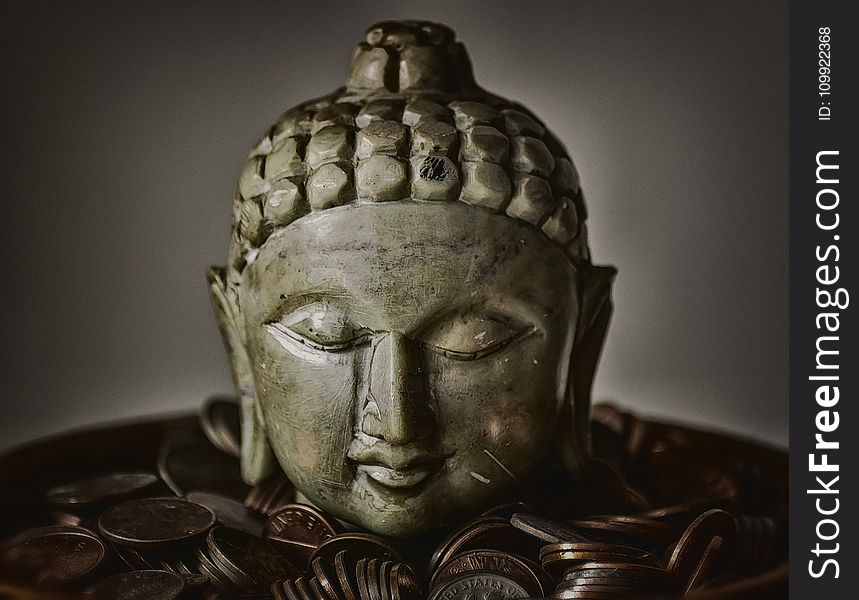 Gautama Buddha Bust Surrounded by Coins